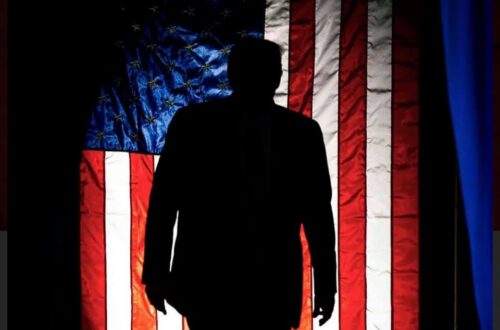 Silhoette of president trump with the american flag as a backdrop