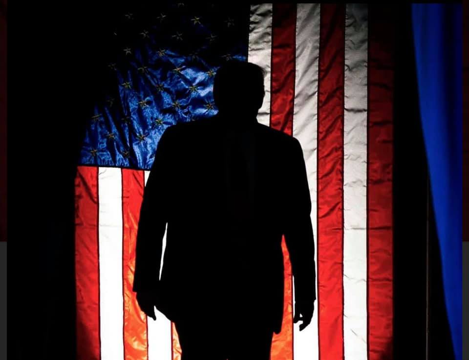 Silhoette of president trump with the american flag as a backdrop