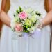 The good wife. A bride standing holdinga beautiful bouqette